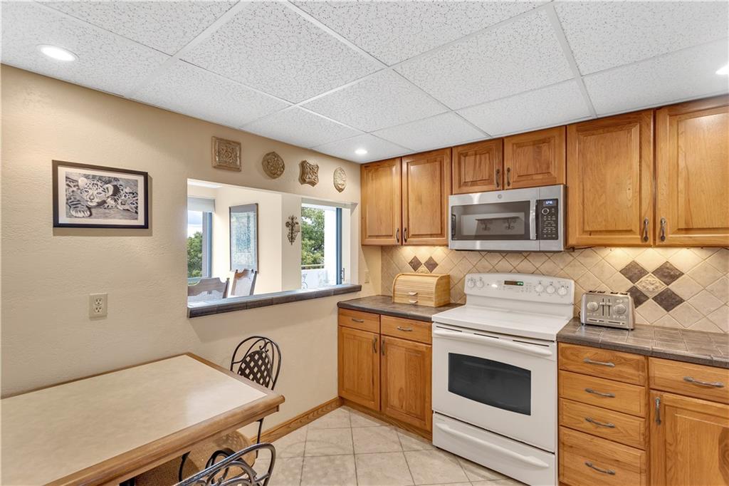 900 Washington Road, Unit 412 Pittsburgh, PA 15228 - Photo 13 of 34 a kitchen with stainless steel appliances a stove microwave and cabinets