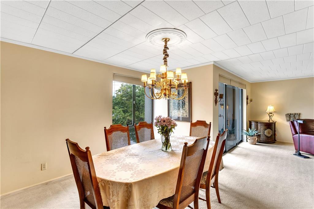 900 Washington Road, Unit 412 Pittsburgh, PA 15228 - Photo 16 of 34 a view of a dining room with furniture and chandelier