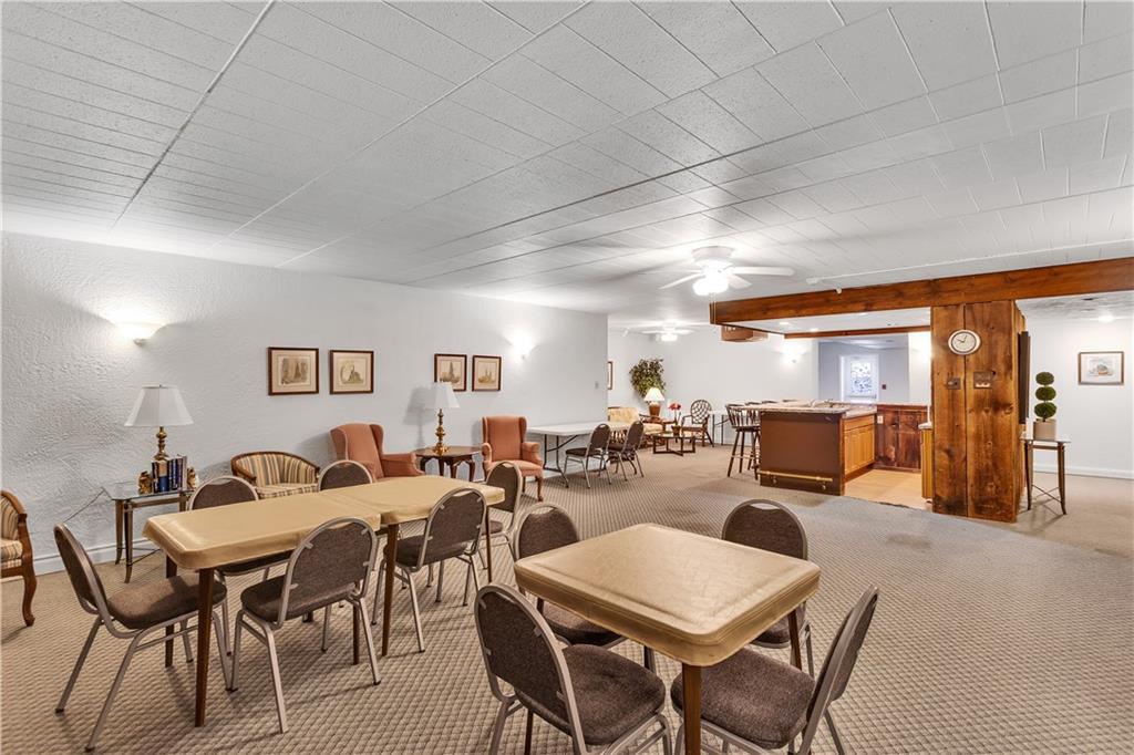 900 Washington Road, Unit 412 Pittsburgh, PA 15228 - Photo 29 of 34 a living room with lots of furniture and a dining table with chairs