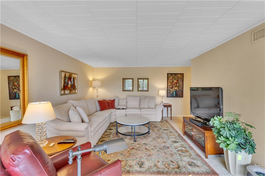 900 Washington Road, Unit 412 Pittsburgh, PA 15228 - Photo 9 of 34 a living room with furniture and a flat screen tv