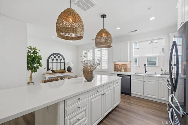 a view of a dining room with furniture kitchen and wooden floor