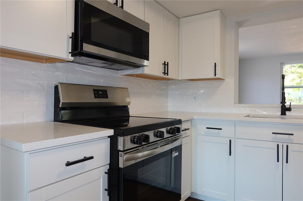 7521 Coventry Drive Port Richey, FL 34668 - Photo 11 of 45 a kitchen with cabinets appliances and a sink