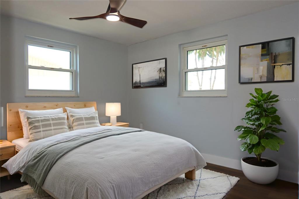 7521 Coventry Drive Port Richey, FL 34668 - Photo 23 of 45 a bedroom with a bed and a potted plant