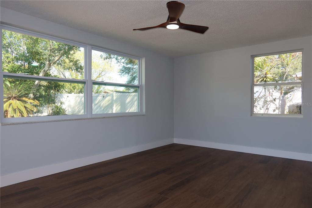7521 Coventry Drive Port Richey, FL 34668 - Photo 26 of 45 a view of an empty room with wooden floor and a window