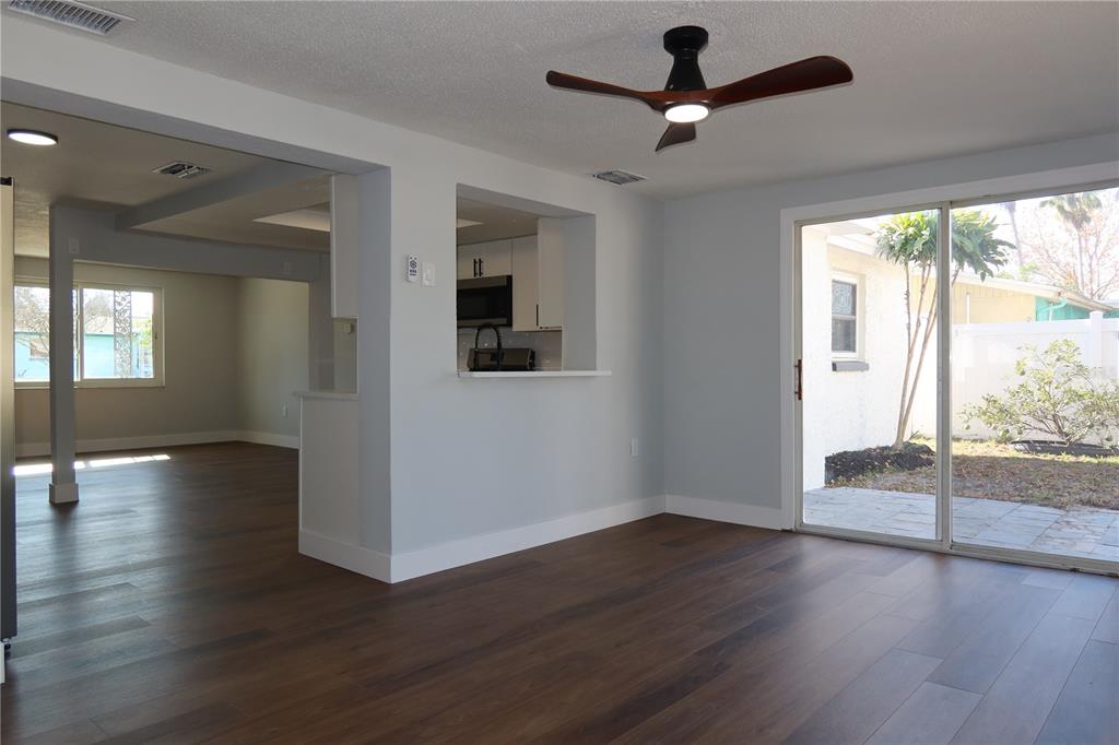 7521 Coventry Drive Port Richey, FL 34668 - Photo 29 of 45 a view of an empty room with wooden floor and a window