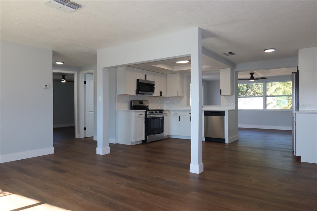 7521 Coventry Drive Port Richey, FL 34668 - Photo 4 of 45 a kitchen with wooden floors and appliances