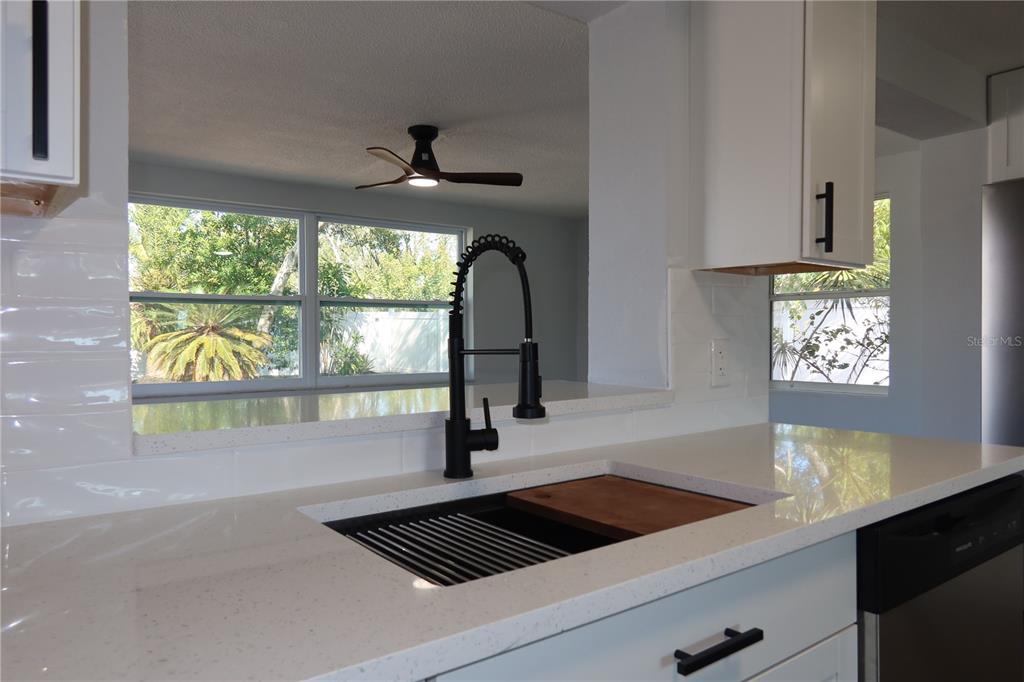 7521 Coventry Drive Port Richey, FL 34668 - Photo 8 of 45 a kitchen with a window a sink and a counter top space