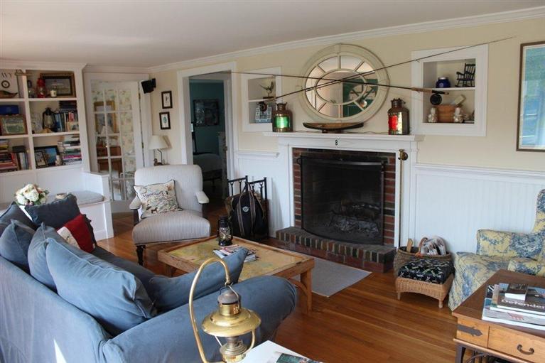 39 Pine Grove Road Chatham, MA 02633 - Photo 12 of 34 a living room with furniture a rug and a fireplace