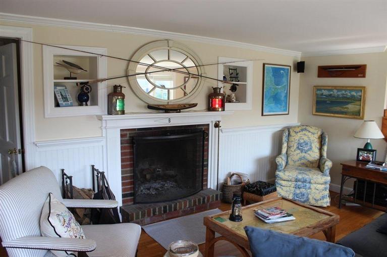 39 Pine Grove Road Chatham, MA 02633 - Photo 13 of 34 a living room with furniture a rug and a fireplace