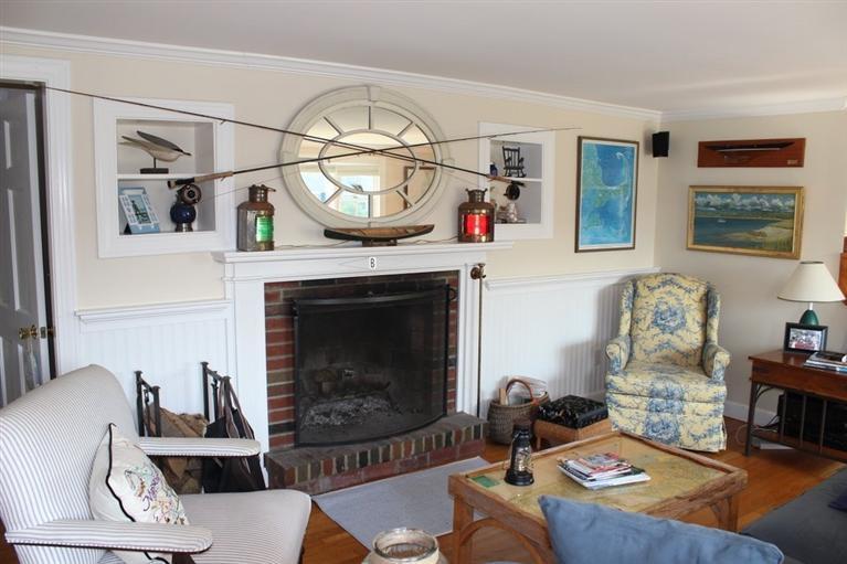 39 Pine Grove Road Chatham, MA 02633 - Photo 14 of 34 a living room with furniture a rug and a fireplace