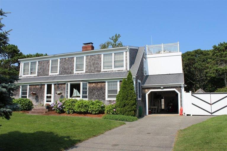39 Pine Grove Road Chatham, MA 02633 - Photo 2 of 34 a front view of a house with a yard