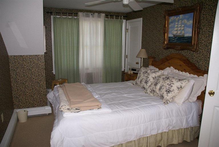 39 Pine Grove Road Chatham, MA 02633 - Photo 25 of 34 a bedroom with a bed and a mirror