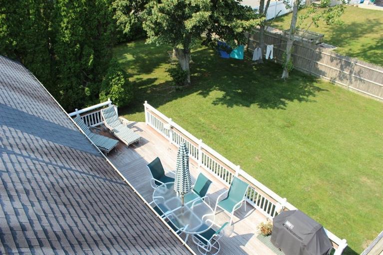39 Pine Grove Road Chatham, MA 02633 - Photo 29 of 34 a balcony with wooden floor and yard in the back