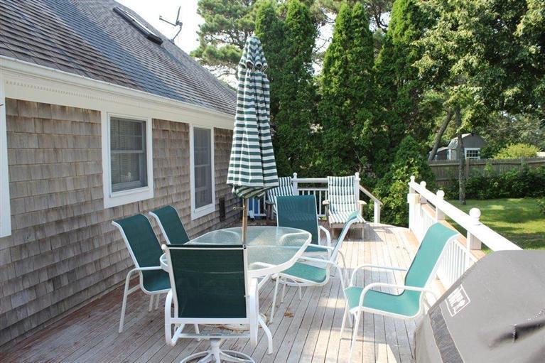 39 Pine Grove Road Chatham, MA 02633 - Photo 30 of 34 a view of a patio with a dining table and chairs