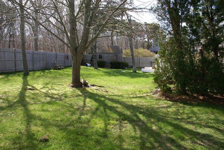 39 Pine Grove Road Chatham, MA 02633 - Photo 34 of 34 a backyard of a house with lots of green space