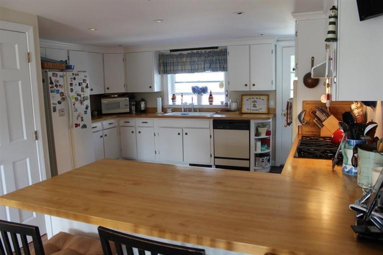 39 Pine Grove Road Chatham, MA 02633 - Photo 6 of 34 a kitchen with stainless steel appliances a stove a sink and a refrigerator