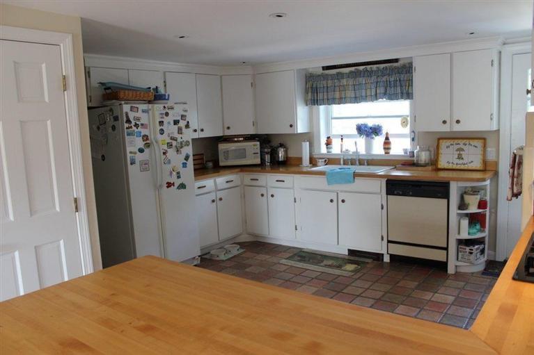 39 Pine Grove Road Chatham, MA 02633 - Photo 7 of 34 a kitchen with stainless steel appliances a refrigerator sink and cabinets