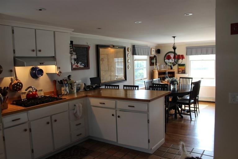 39 Pine Grove Road Chatham, MA 02633 - Photo 9 of 34 a kitchen with white cabinets and sink