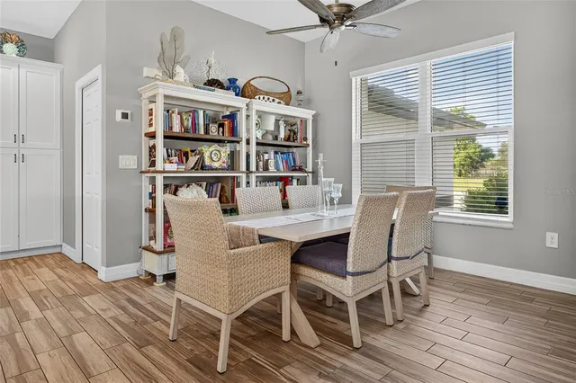 a view of a dining room with furniture and wooden floor