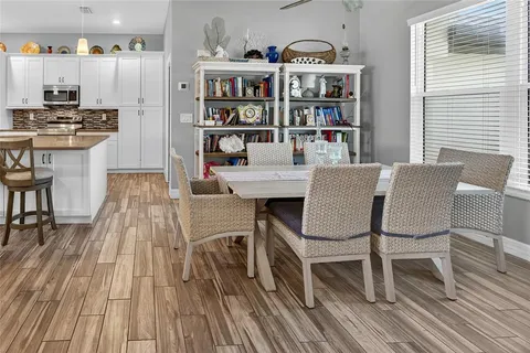 a bed sitting in a bedroom next to a window with a chandelier