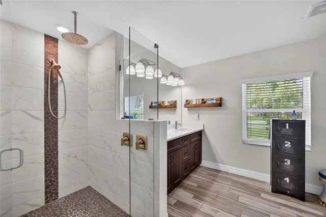 a white bath tub sitting in a bathroom next to a window