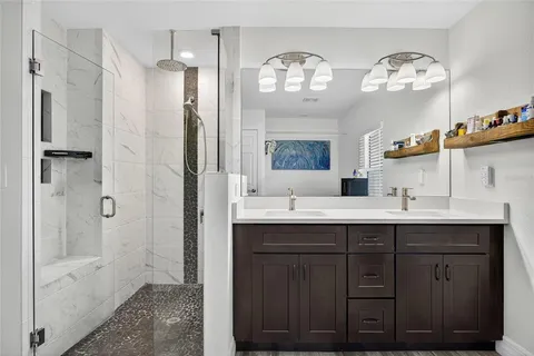 a bedroom with a bed and painting on the wall