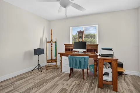 a bathroom with a toilet a sink a mirror and a window