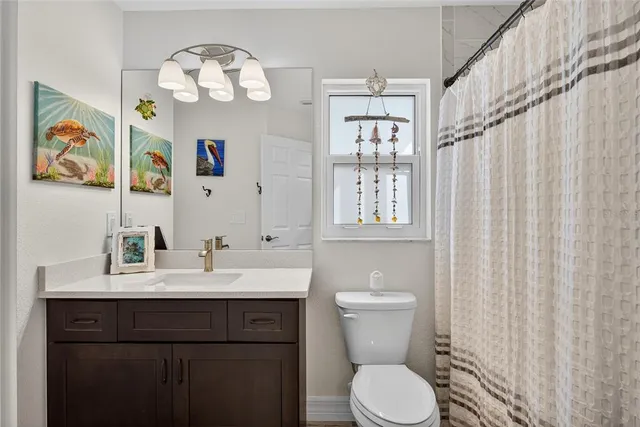 a bathroom with a granite countertop sink a mirror and a shower