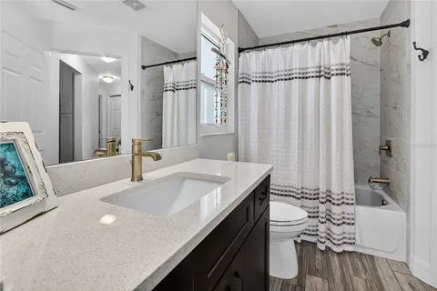 a view of a kitchen with a table and chairs under an umbrella