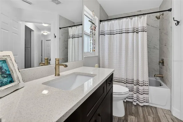a view of a kitchen with a table and chairs under an umbrella