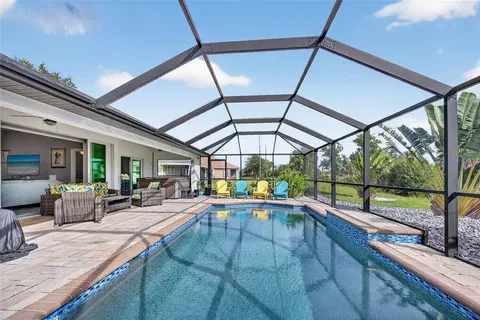 a view of swimming pool with seating area and roof