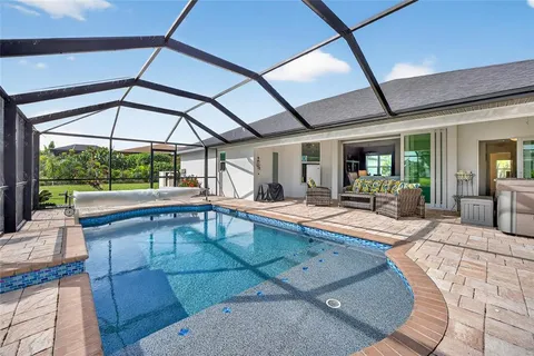 a bedroom with furniture and large windows