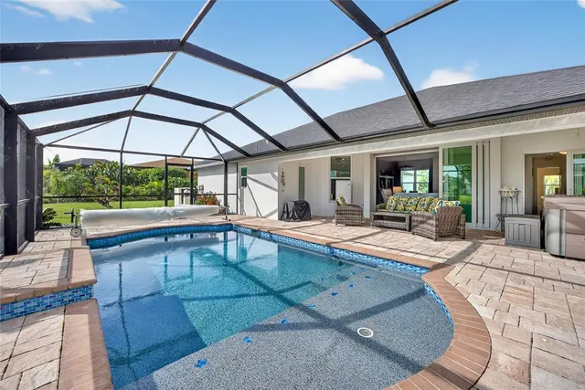 a bedroom with furniture and large windows