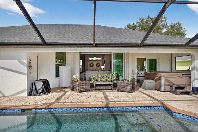 an aerial view of a house with yard swimming pool and outdoor seating
