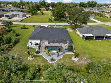 an aerial view of a house with swimming pool patio and outdoor seating