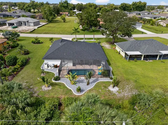 an aerial view of a house with swimming pool patio and outdoor seating