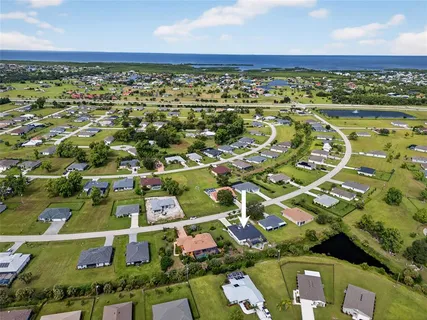 a aerial view of a house with garden space and street view