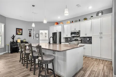 a kitchen with stainless steel appliances a refrigerator and a stove top oven
