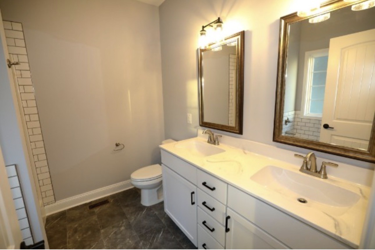 7246 Winding Way Pleasant View, TN 37146 - Photo 12 of 24 a bathroom with a granite countertop sink toilet and shower