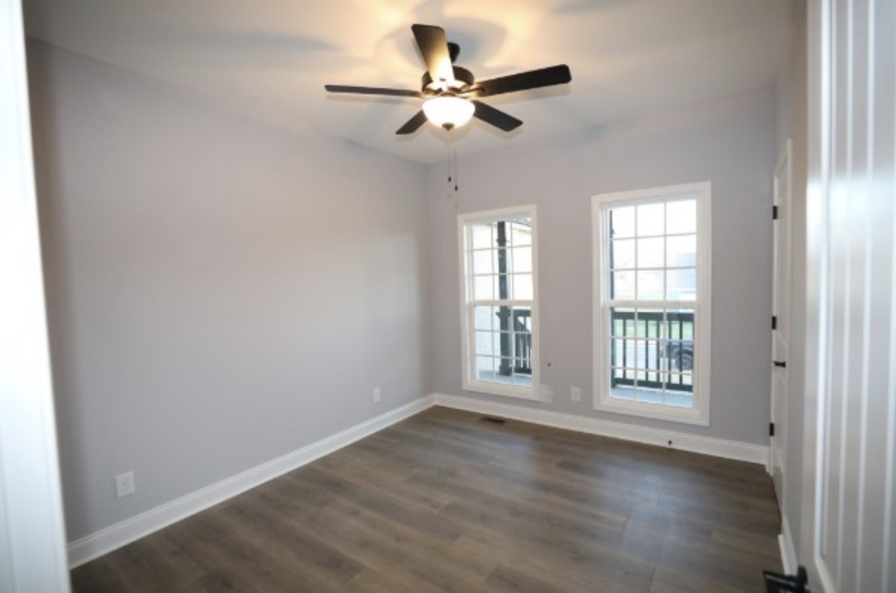 7246 Winding Way Pleasant View, TN 37146 - Photo 17 of 24 an empty room with wooden floor and windows