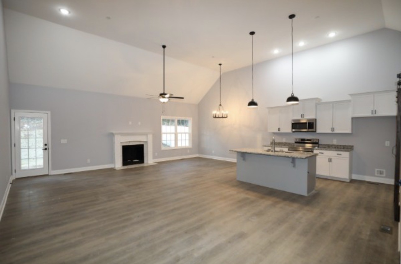 7246 Winding Way Pleasant View, TN 37146 - Photo 23 of 24 a large kitchen with granite countertop a stove a sink dishwasher a refrigerator and wooden floor