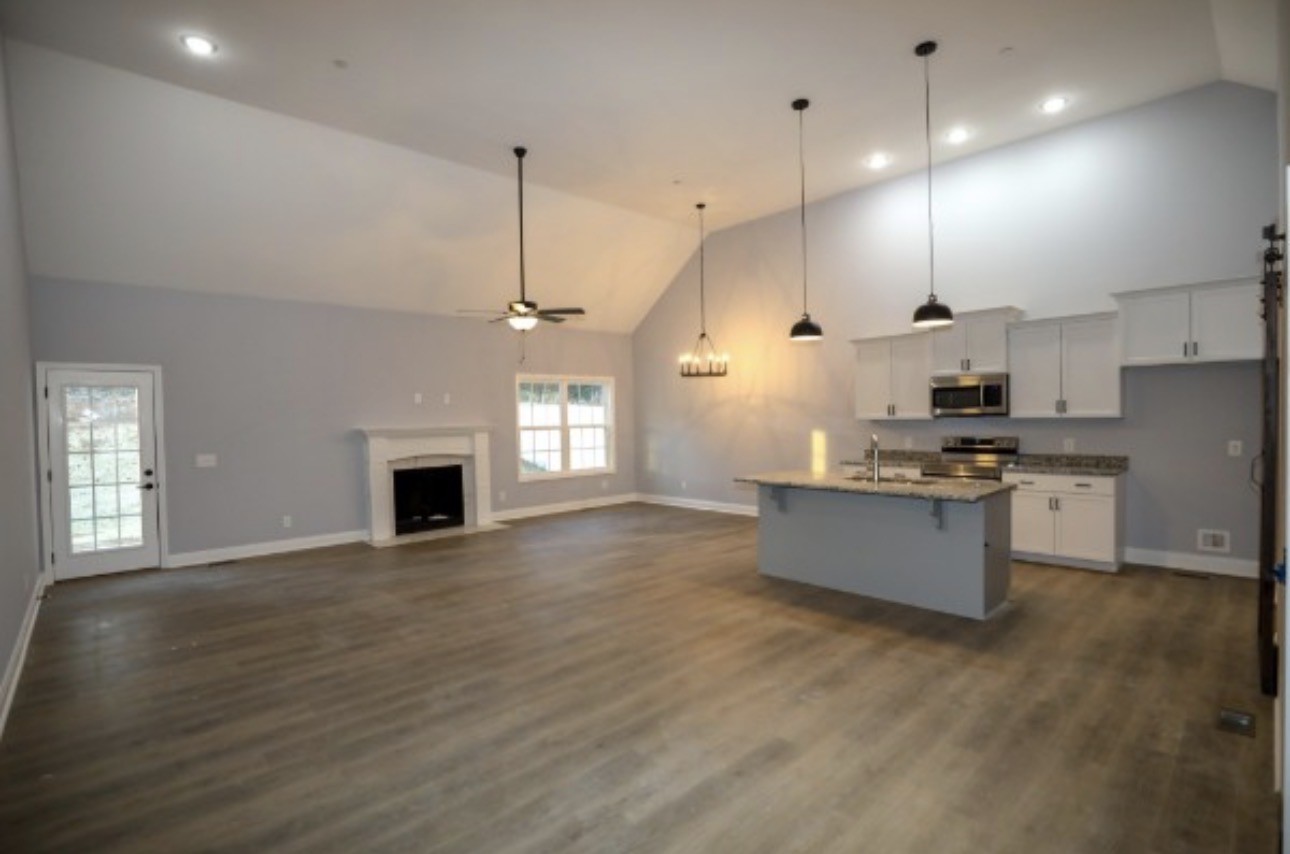 7246 Winding Way Pleasant View, TN 37146 - Photo 4 of 24 a large kitchen with kitchen island a sink dishwasher a stove and a refrigerator with wooden floor