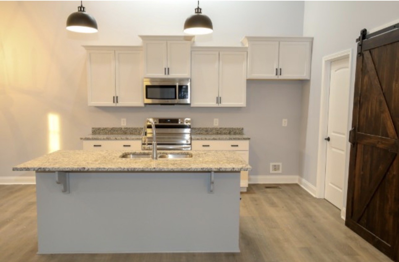 7246 Winding Way Pleasant View, TN 37146 - Photo 5 of 24 a kitchen with stainless steel appliances granite countertop a sink a stove a refrigerator and white cabinets