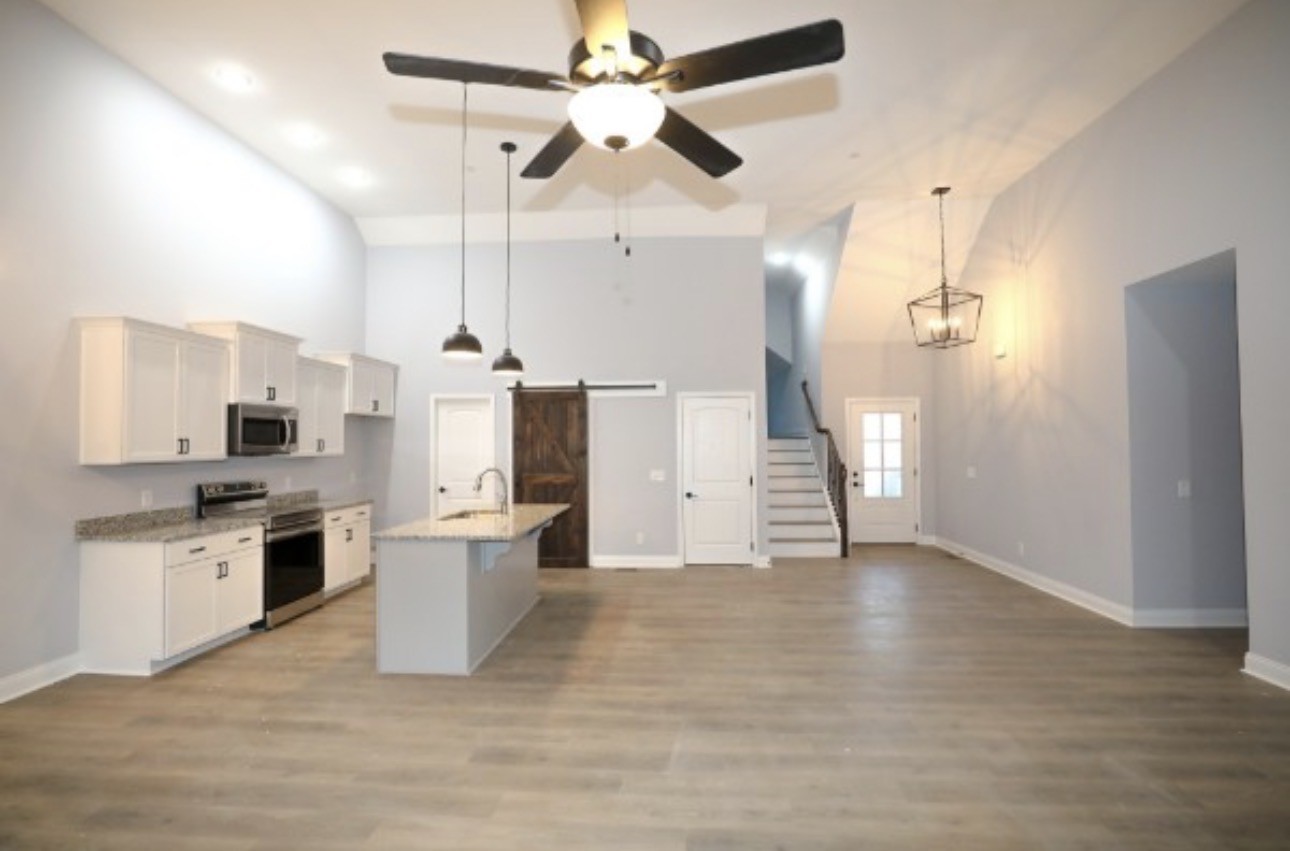 7246 Winding Way Pleasant View, TN 37146 - Photo 8 of 24 a kitchen with stainless steel appliances a stove a refrigerator and a chandelier