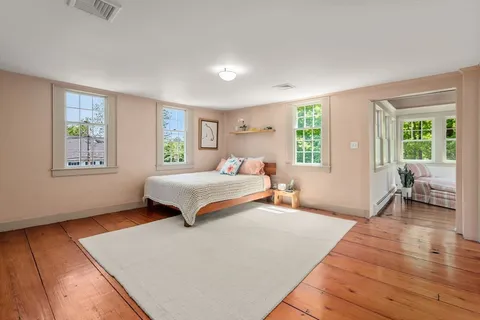 a bedroom with a large bed and a window