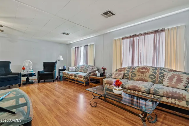 a living room with furniture and a wooden floor