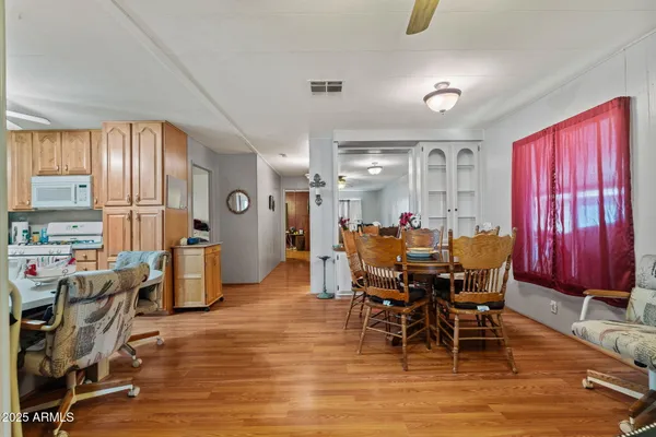 a view of a dining room with furniture window and wooden floor