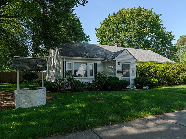 a front view of house with a garden