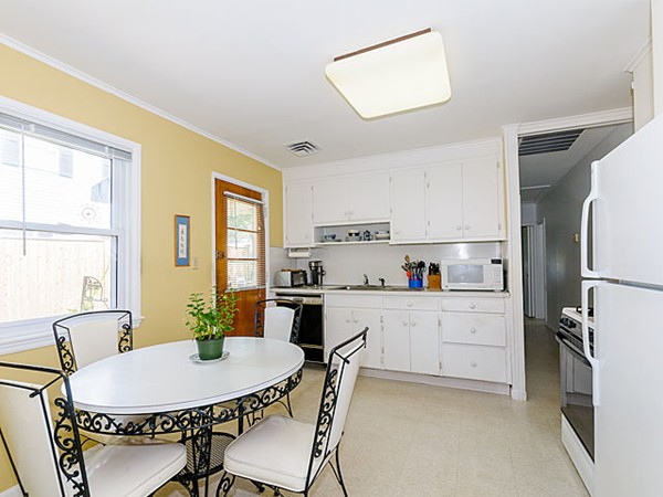 192 Spiers Road Newton, MA 02459 - Photo 6 of 15 a kitchen with stainless steel appliances a dining table chairs and a refrigerator