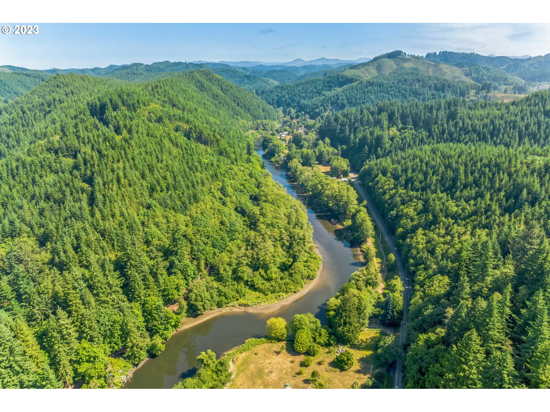 Elk City Road Toledo, OR 97391 - Photo 10 of 34 a view of a lush green forest with a house